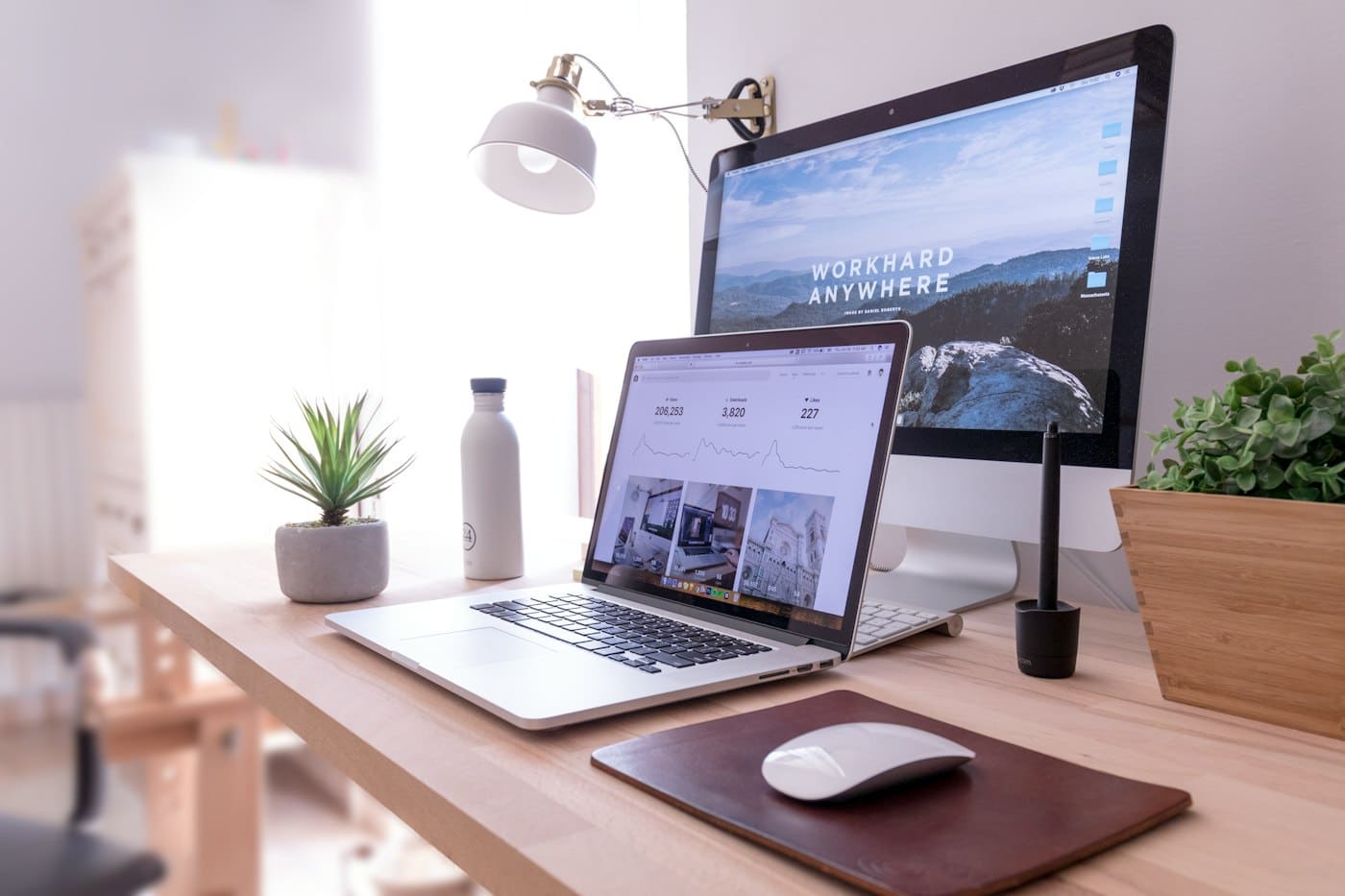 Tidy desk with a laptop and a large monitor, ready for work