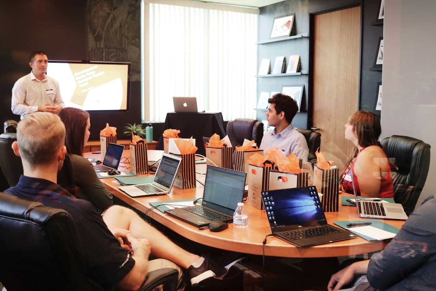 Founders and investors around a boardroom table reviewing papers