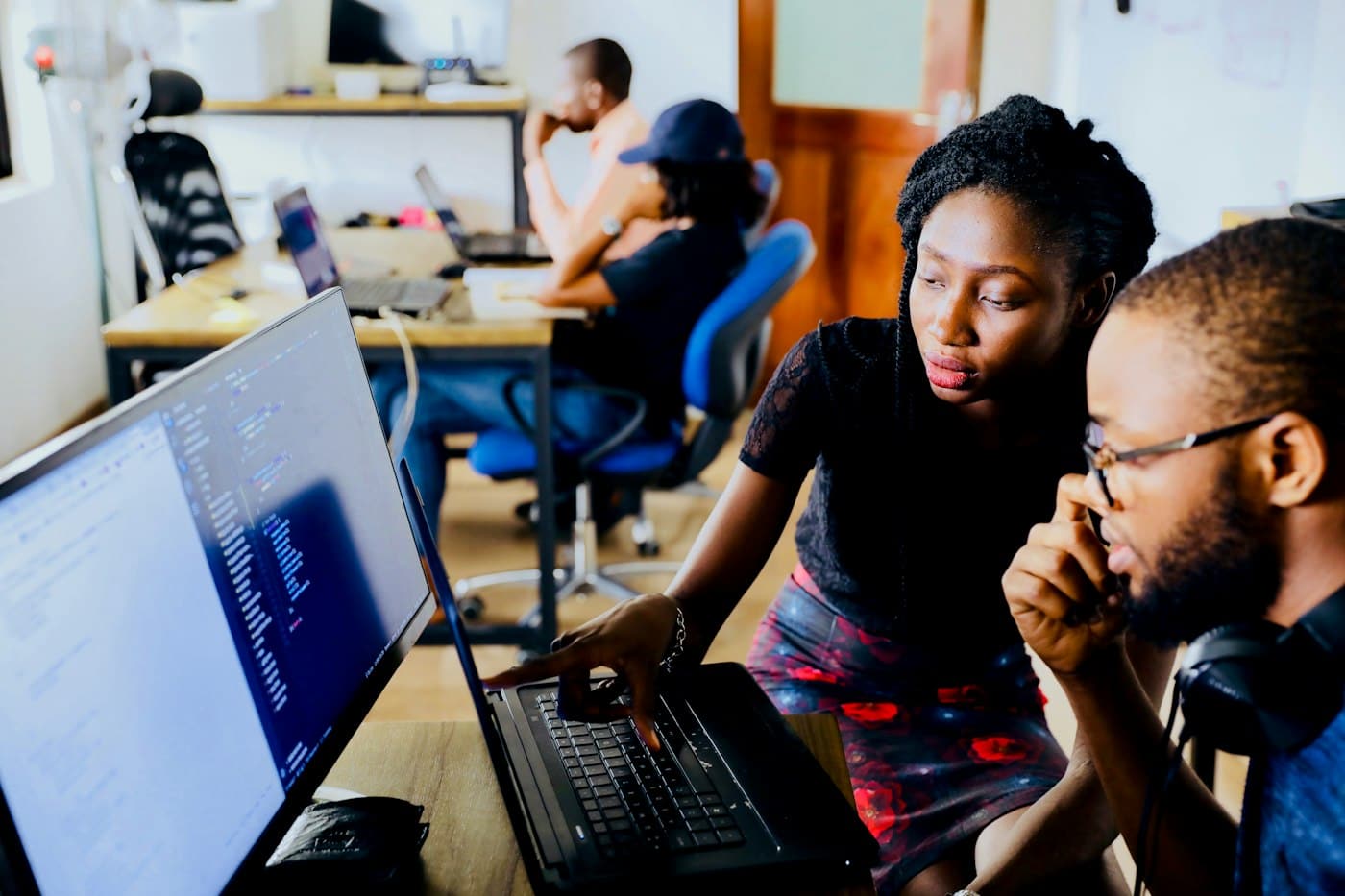 A team reviewing documents together on laptop screens