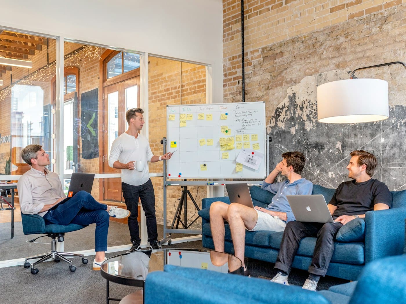 Startup team standing around a table during a morning planning meeting