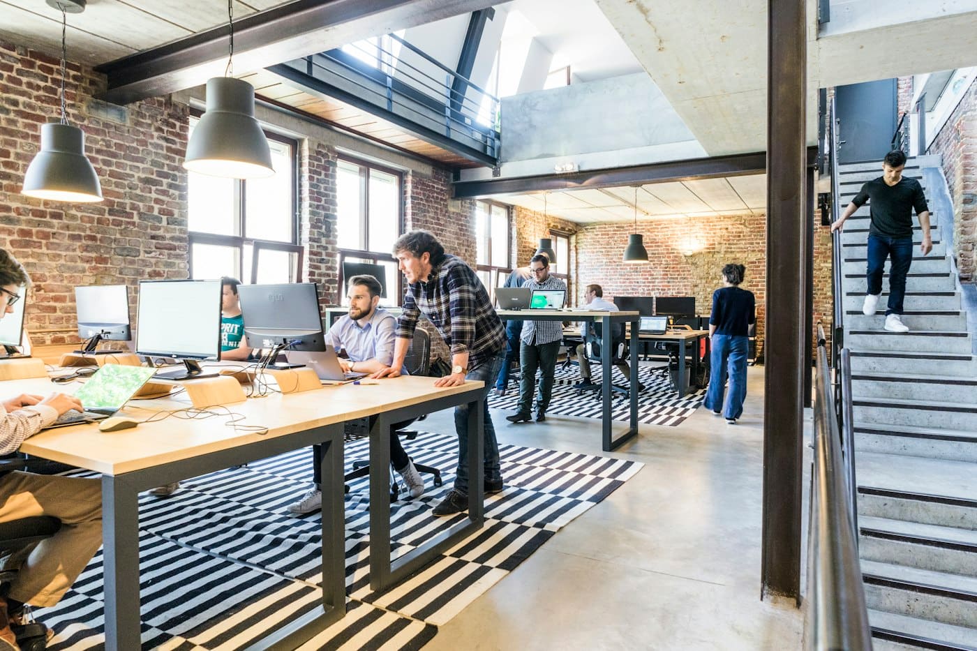 Open-plan startup office with a team working at long desks